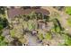 An aerial view showcases the vast wooded property and the charming pond, offering a serene natural setting at 170 Dusty Loop Dr, Mount Gilead, NC 27306