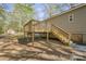 Spacious wooden back deck with stairs and railings on an elevated home, perfect for outdoor relaxation at 170 Dusty Loop Dr, Mount Gilead, NC 27306
