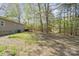 Home's expansive backyard features lush greenery and a charming deck, perfect for outdoor enjoyment at 170 Dusty Loop Dr, Mount Gilead, NC 27306