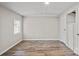 Bright bedroom with neutral walls, wood-look floors, and a window at 170 Dusty Loop Dr, Mount Gilead, NC 27306