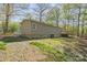 Exterior view of the home's side, with a well-maintained lawn and cozy back deck at 170 Dusty Loop Dr, Mount Gilead, NC 27306