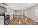 Open-concept living area with wood-look floors and stainless steel appliances at 170 Dusty Loop Dr, Mount Gilead, NC 27306