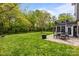 Beautiful backyard featuring a patio with a dining set, a fire pit, and a well-maintained lawn at 1809 Robbins Meadows Dr, Waxhaw, NC 28173