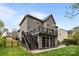 Large, lush backyard featuring a second story deck, screened in porch, and spacious patio at 1809 Robbins Meadows Dr, Waxhaw, NC 28173