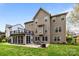 Spacious backyard featuring a screened in porch, second story deck and a cozy patio with a fire pit at 1809 Robbins Meadows Dr, Waxhaw, NC 28173