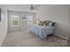 Cozy bedroom with neutral walls, carpet, two windows, and a ceiling fan offering a relaxing space at 1809 Robbins Meadows Dr, Waxhaw, NC 28173