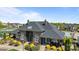 Clubhouse featuring stone accents, beautiful landscaping, and a black shingle roof at 1809 Robbins Meadows Dr, Waxhaw, NC 28173