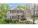 Charming two-story brick home with a well-manicured front yard, black shutters, and a covered entrance at 1809 Robbins Meadows Dr, Waxhaw, NC 28173