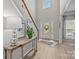 Bright foyer with wood flooring, a high ceiling and staircase; a welcoming entrance at 1809 Robbins Meadows Dr, Waxhaw, NC 28173