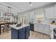 Open eat-in kitchen with stainless steel appliances, subway tile backsplash and blue island at 1809 Robbins Meadows Dr, Waxhaw, NC 28173