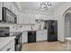 Efficient kitchen with modern appliances, tile floors, white cabinets and subway tile backsplash at 1809 Robbins Meadows Dr, Waxhaw, NC 28173