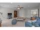 Comfortable living room showcases stylish furniture, a flat screen TV, and ceiling fan at 1809 Robbins Meadows Dr, Waxhaw, NC 28173