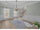 Inviting living room featuring a decorative chandelier, hardwood floors and stylish staircase at 1809 Robbins Meadows Dr, Waxhaw, NC 28173