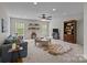 Spacious living room with windows, built-in shelves, and a comfortable seating area at 1809 Robbins Meadows Dr, Waxhaw, NC 28173