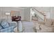 Comfortable living room showcases piano, elegant stairway, soft rug, and cozy furniture at 1809 Robbins Meadows Dr, Waxhaw, NC 28173