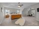 Spacious main bedroom with tray ceiling, dual windows, and comfortable sitting area at 1809 Robbins Meadows Dr, Waxhaw, NC 28173