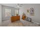 Bright office with natural light from two windows, a ceiling fan and decorative art at 1809 Robbins Meadows Dr, Waxhaw, NC 28173