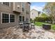 Cozy backyard patio featuring comfortable seating, a fire pit, and lush green lawn and manicured landscaping at 1809 Robbins Meadows Dr, Waxhaw, NC 28173