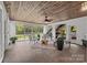 Bright sunroom with wood ceiling, tile floors, large windows providing ample natural light, and stylish furniture at 1809 Robbins Meadows Dr, Waxhaw, NC 28173