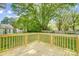 New back deck overlooks a yard with mature trees and a shed at 1901 Parkdale Ave, Gastonia, NC 28052