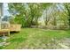 Enjoy the serene backyard with mature trees, lush greenery, and a wooden fence at 1901 Parkdale Ave, Gastonia, NC 28052