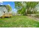Spacious backyard with lush green grass, mature trees, and a wooden fence for privacy at 1901 Parkdale Ave, Gastonia, NC 28052