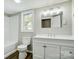 Bathroom features a white vanity and a tub-shower combo with a window at 1901 Parkdale Ave, Gastonia, NC 28052