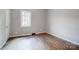 Bedroom showcases wood-look flooring and one window at 1901 Parkdale Ave, Gastonia, NC 28052
