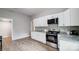 Modern kitchen boasts white cabinets, granite counters, and stainless steel appliances at 1901 Parkdale Ave, Gastonia, NC 28052