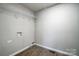 Laundry room with wood-look flooring and a white wire shelf installed at 1901 Parkdale Ave, Gastonia, NC 28052