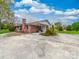 Brick home showcasing an attached carport and spacious concrete driveway at 1910 York Hwy, York, SC 29745