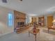 Cozy living room featuring a brick fireplace, decorative windows and neutral carpet at 1910 York Hwy, York, SC 29745