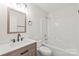 Modern bathroom features a wood-framed mirror and a sleek vanity with updated fixtures at 219 Edinburgh Ct, Mount Holly, NC 28120