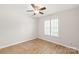 Bright bedroom with a ceiling fan and a window with white blinds and wood laminate flooring at 219 Edinburgh Ct, Mount Holly, NC 28120