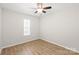 Cozy bedroom with wood flooring, ceiling fan, and a window for natural light at 219 Edinburgh Ct, Mount Holly, NC 28120