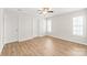 Bedroom with wood flooring, ceiling fan, and natural light from a window at 219 Edinburgh Ct, Mount Holly, NC 28120