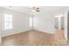 Light-filled bedroom with wood flooring, ceiling fan, and window with shutters at 219 Edinburgh Ct, Mount Holly, NC 28120