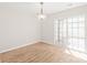 Dining room area featuring light wood floors and a sliding glass door at 219 Edinburgh Ct, Mount Holly, NC 28120
