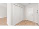 Entryway with wood flooring, closet, and white door, providing ample storage space at 219 Edinburgh Ct, Mount Holly, NC 28120