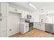 Bright, modern kitchen features white cabinets, stainless steel appliances and light blue subway tile backsplash at 219 Edinburgh Ct, Mount Holly, NC 28120