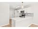 The kitchen features white cabinets, stainless appliances, modern lighting, and a breakfast bar at 219 Edinburgh Ct, Mount Holly, NC 28120