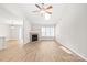 A spacious living room features light wood floors, a fireplace, vaulted ceilings, and lots of natural light at 219 Edinburgh Ct, Mount Holly, NC 28120