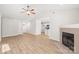 Open-concept living room with fireplace, wood flooring, and natural light at 219 Edinburgh Ct, Mount Holly, NC 28120
