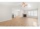 Spacious living room features light wood floors, a fireplace, vaulted ceilings, and lots of natural light at 219 Edinburgh Ct, Mount Holly, NC 28120