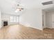 Spacious living room features light wood floors, a fireplace, vaulted ceilings, and lots of natural light at 219 Edinburgh Ct, Mount Holly, NC 28120