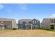 Backyard view of a two-story home with well-maintained lawn and patio seating area at 235 Boxelder Rd, Clover, SC 29710