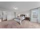 Bright bedroom with neutral walls, cozy carpet, a queen bed, and natural light from large window at 235 Boxelder Rd, Clover, SC 29710