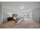 Spacious bedroom boasts plush carpet, natural light from large windows, and neutral tones at 235 Boxelder Rd, Clover, SC 29710