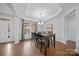 Bright dining room featuring hardwood floors, coffered ceiling, large windows and a modern light fixture at 235 Boxelder Rd, Clover, SC 29710