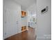 Bright entryway features coat rack and storage, flowing into an open-concept kitchen area with hardwood floors at 235 Boxelder Rd, Clover, SC 29710
